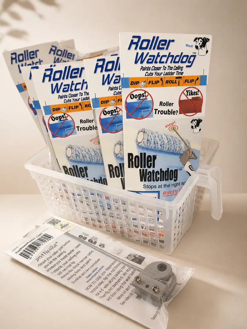 A white plastic basket holding multiple packages of Roller Watchdog dog training mats, with one sealed package and the roller attachment placed in front on a light beige surface.